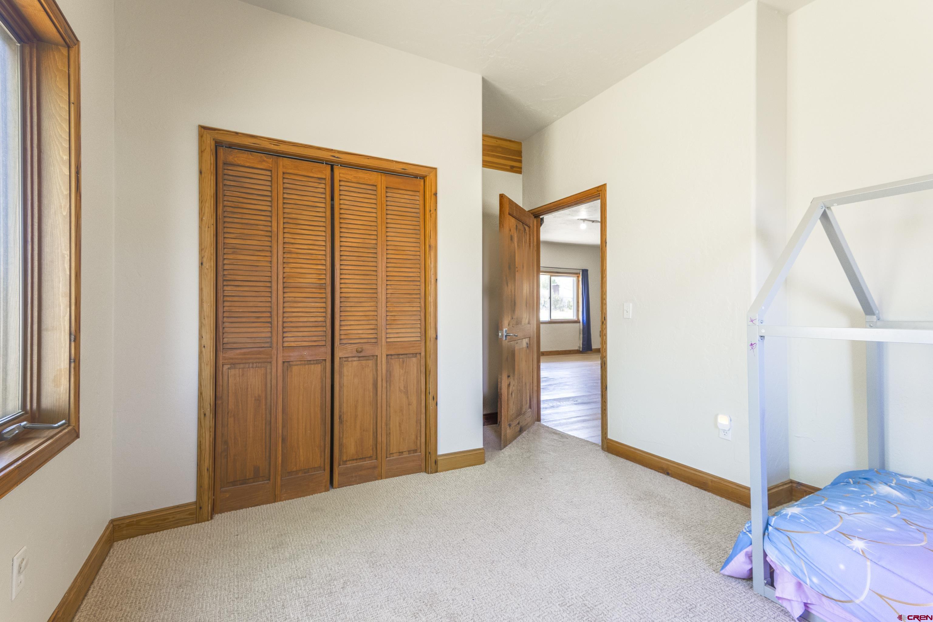 388 Columbine Road Gunnison, CO 81230 - Photo 7 of 45 a bedroom with windows