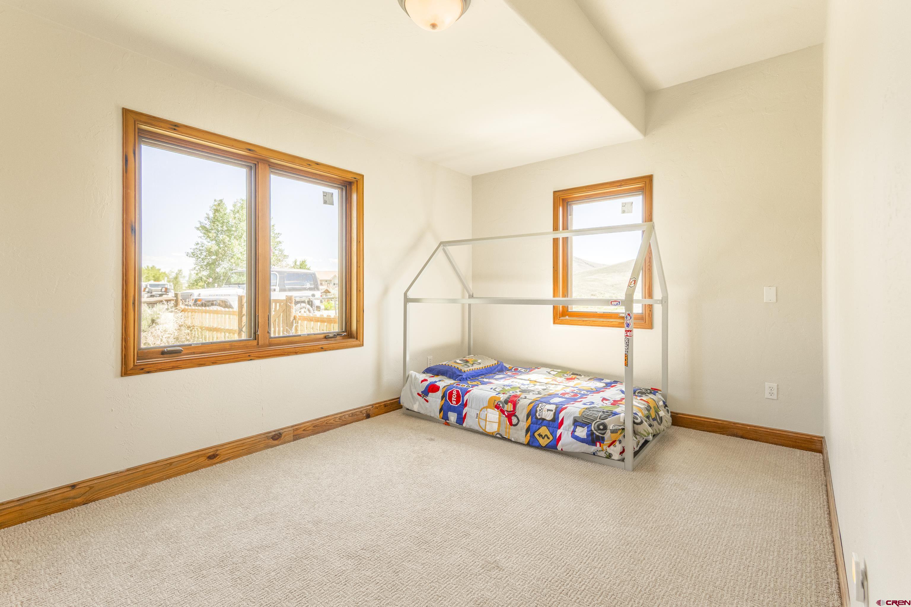 388 Columbine Road Gunnison, CO 81230 - Photo 8 of 45 a bedroom with a bed and a window
