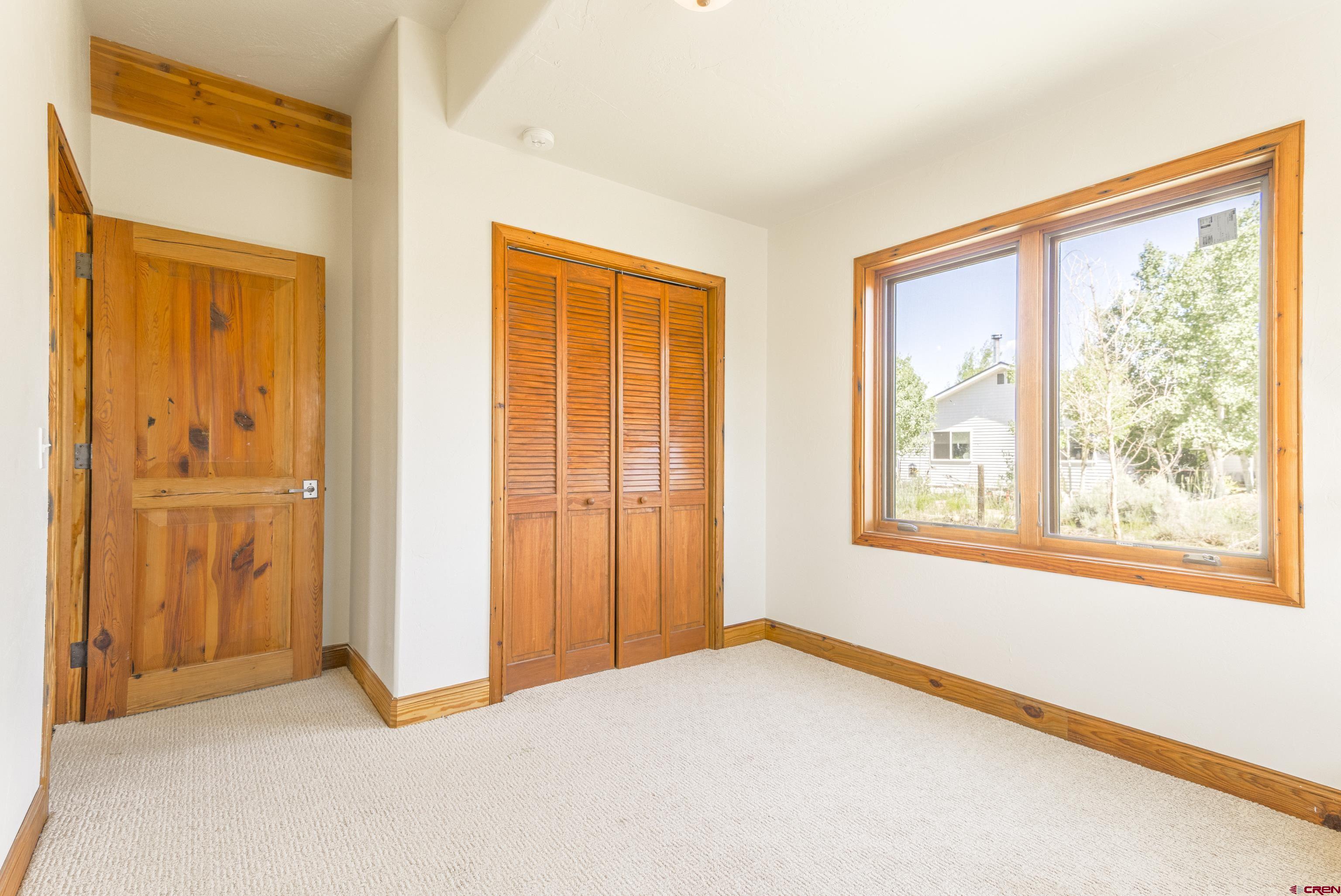 388 Columbine Road Gunnison, CO 81230 - Photo 9 of 45 a view of an empty room with a window