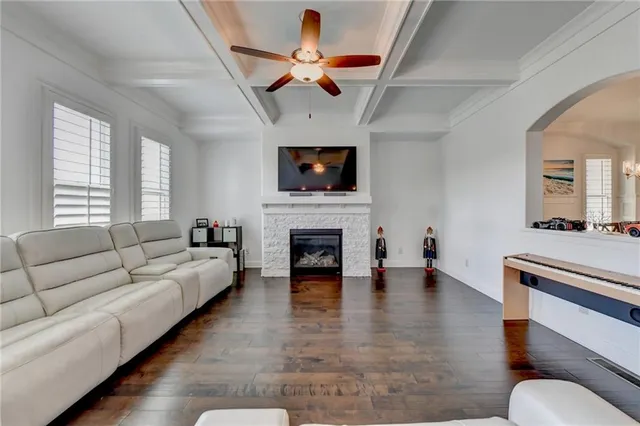 a living room with furniture and wooden floor