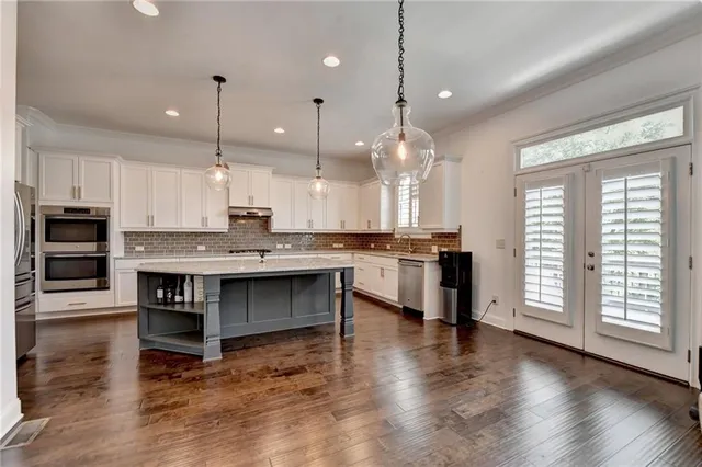 a view of a hallway with wooden floor and stairs