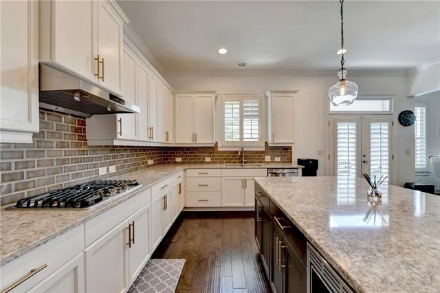 a bathroom with a granite countertop sink mirror and a bathtub