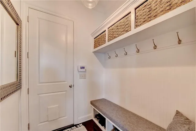a bathroom with a granite countertop sink a mirror and a shower