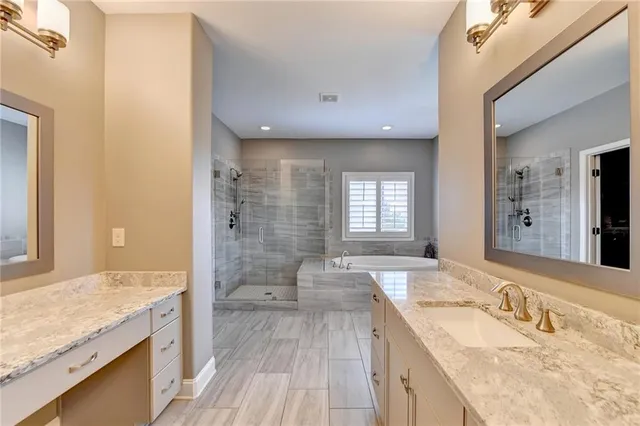 a kitchen with stainless steel appliances a sink a stove a refrigerator and island