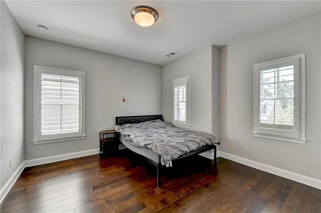 a bathroom with a toilet sink vanity and mirror