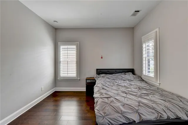 a view of a house with a big yard potted plants and a large tree