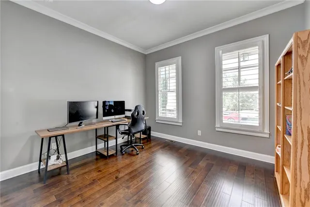 a view of a workspace with furniture and a bookshelf