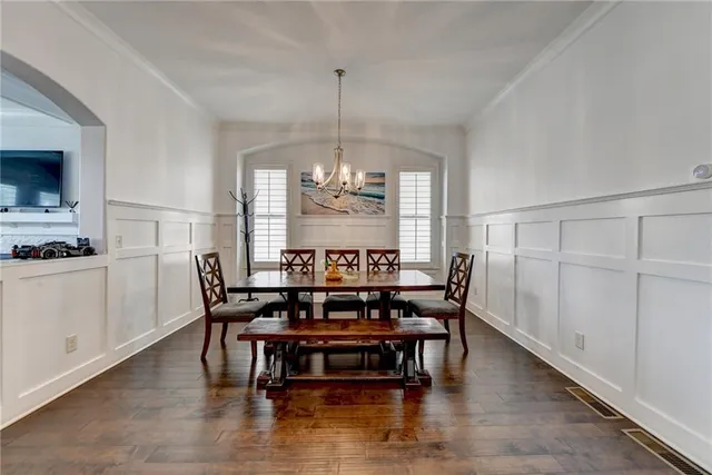 a view of a dining room with furniture and chandelier
