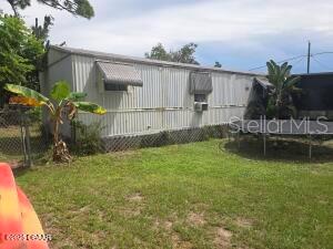 117 Coleman Street Edgewater, FL 32141 - Photo 3 of 5 a backyard of a house with lots of green space and fountain
