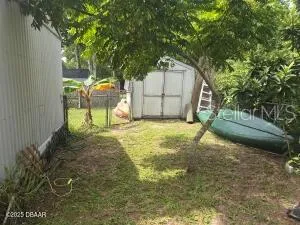 a backyard of a house with basket ball court table and chairs