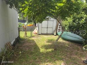 117 Coleman Street Edgewater, FL 32141 - Photo 4 of 5 a backyard of a house with basket ball court table and chairs