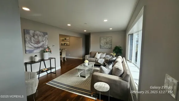 a view of a dining room with furniture and wooden floor