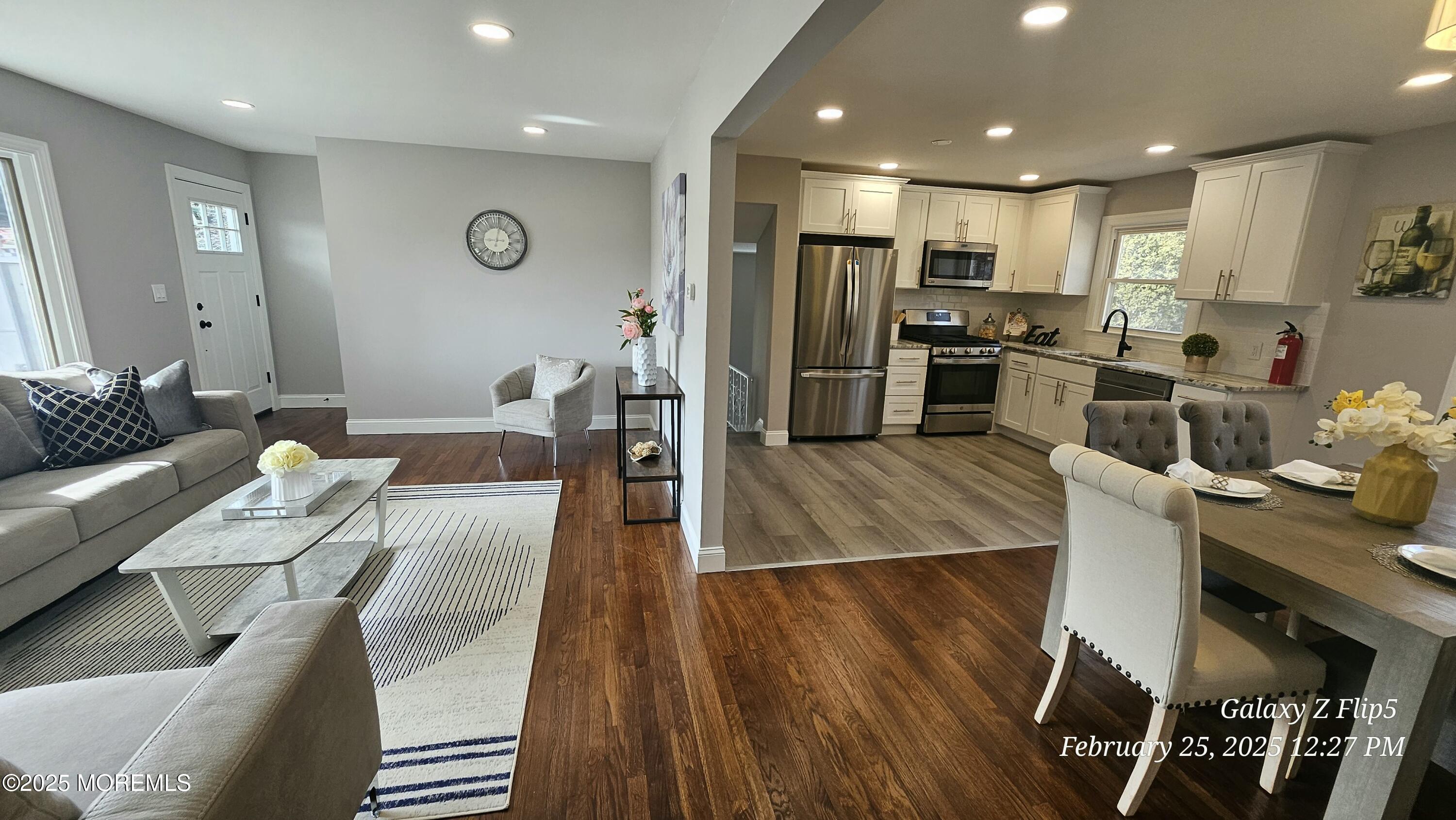 Park Avenue Freehold, NJ 07728 - Photo 4 of 18 a kitchen with stainless steel appliances kitchen island granite countertop a refrigerator oven a sink a dining table and chairs with wooden floor