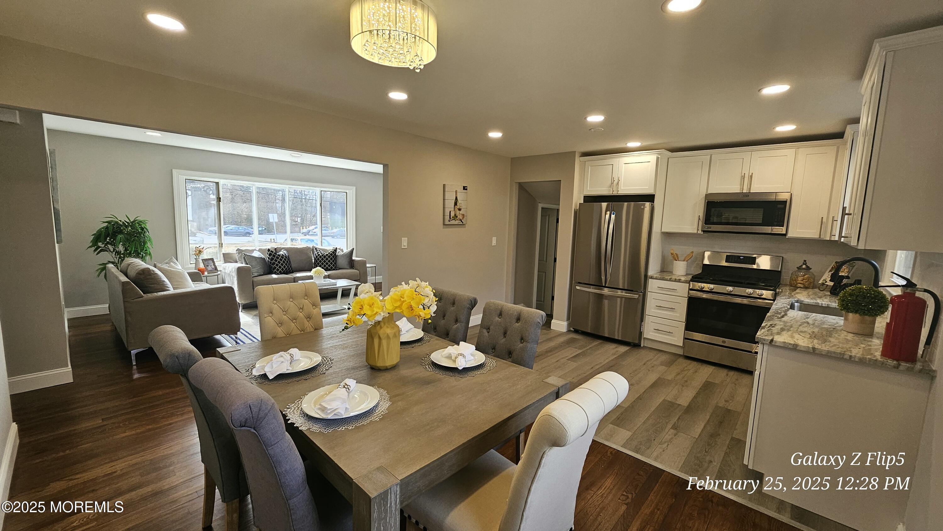 Park Avenue Freehold, NJ 07728 - Photo 5 of 18 a view of a dining room with furniture a kitchen and chandelier