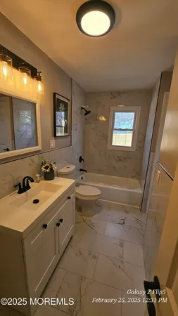 a en suite bathroom with a sink and mirror