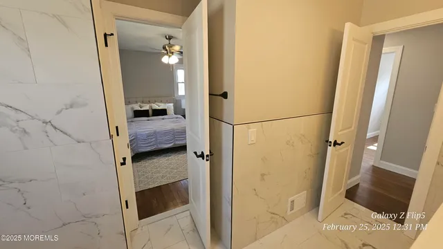 a bedroom with a bed and a chandelier