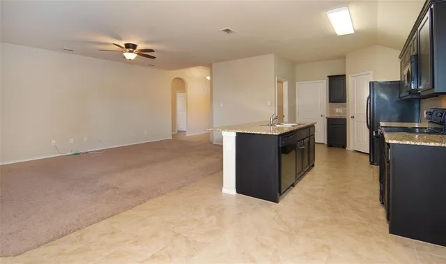 a kitchen with stainless steel appliances granite countertop a stove oven and a refrigerator