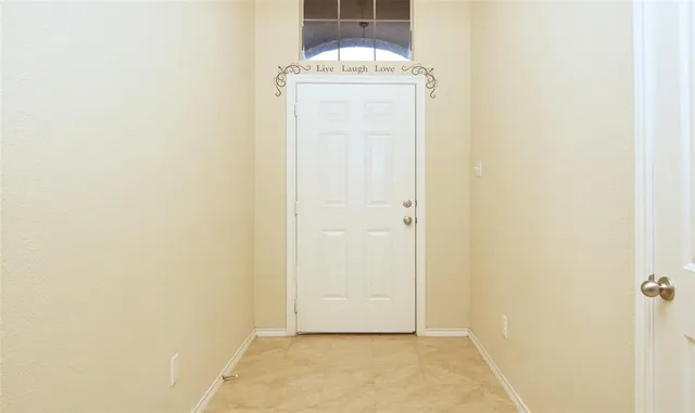 a view of front door with a hallway