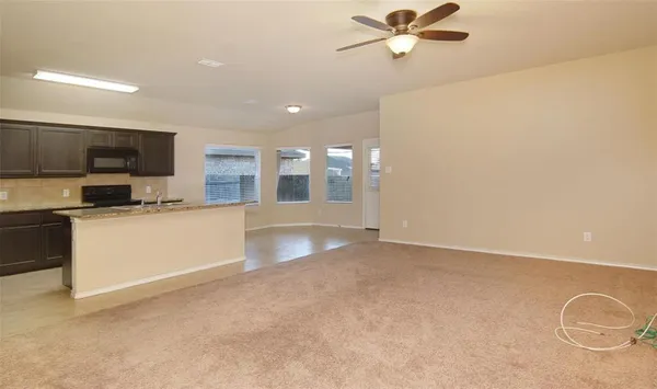 a view of a kitchen with a sink and dishwasher a kitchen island with wooden floor