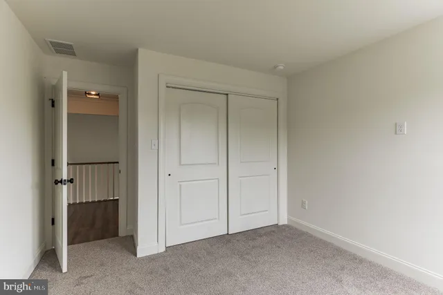 a view of an empty room and closet area