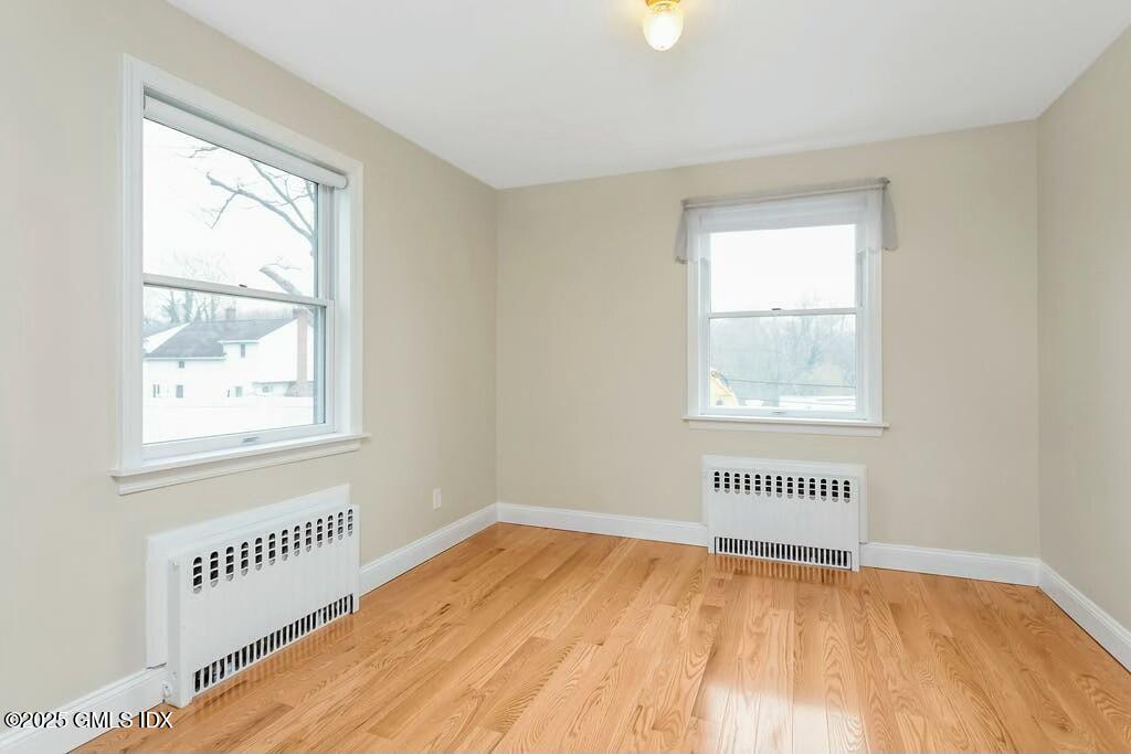 304 Valley Road Cos Cob, CT 06807 - Photo 12 of 21 a view of an empty room with wooden floor and a window