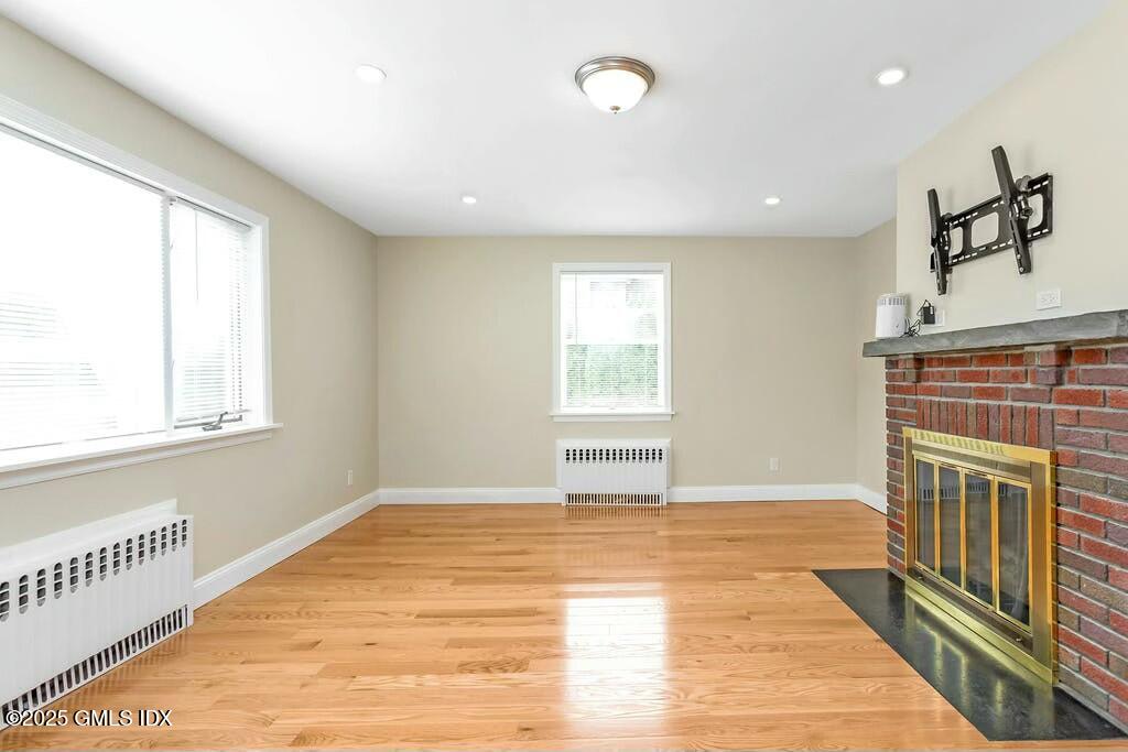 304 Valley Road Cos Cob, CT 06807 - Photo 4 of 21 a view of an empty room with wooden floor and a window