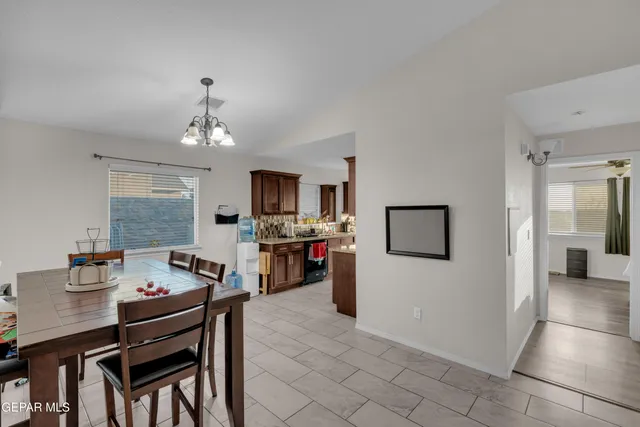 a view of a dining room with furniture and a chandelier