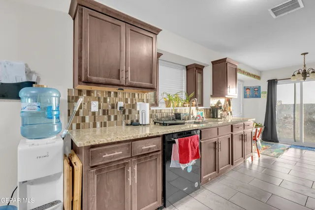 a kitchen with stainless steel appliances granite countertop a sink and cabinets