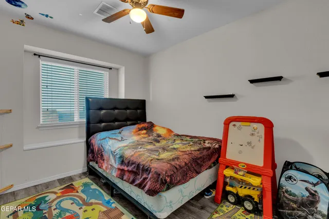 a bedroom with a bed and a dresser