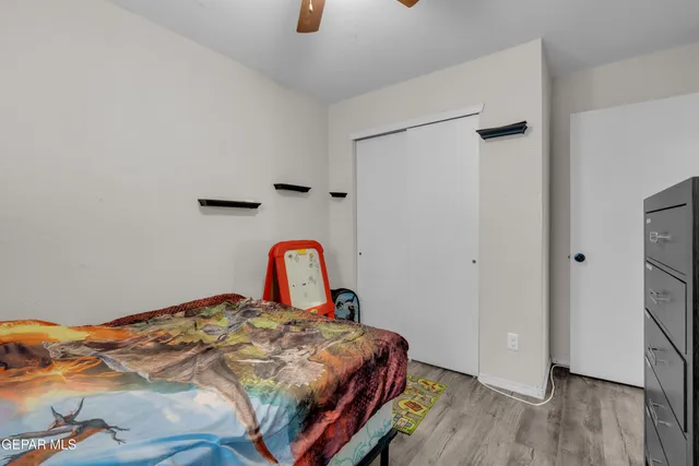 a bedroom with two beds and a chandelier