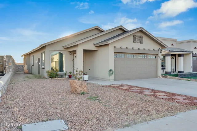 a view of a house with a yard and garage
