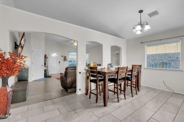 a view of a dining room with furniture and chandelier
