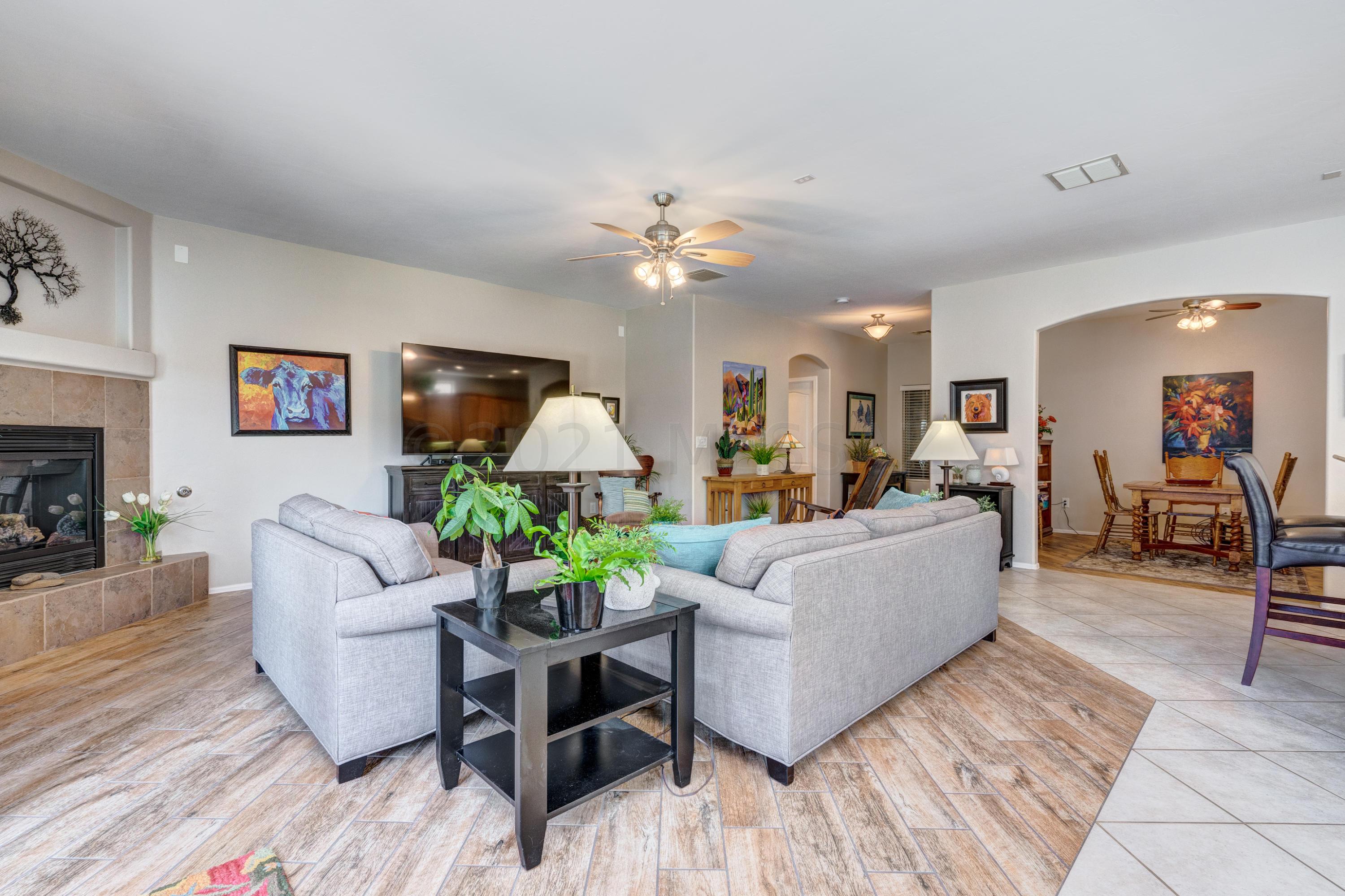 3639 East Northern Dancer Road Tucson, AZ 85739 - Photo 7 of 48 a living room with furniture and a chandelier