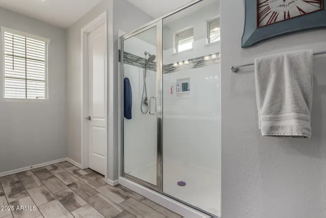 a bathroom with a shower and a sink