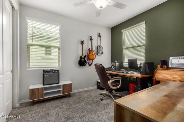a view of a workspace with furniture and a window
