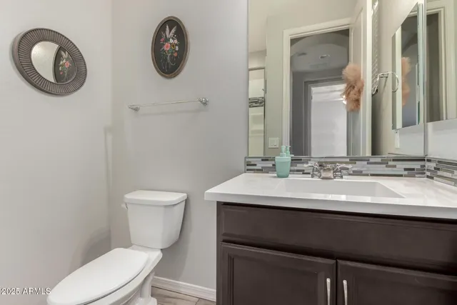 a bathroom with a toilet a sink and a mirror