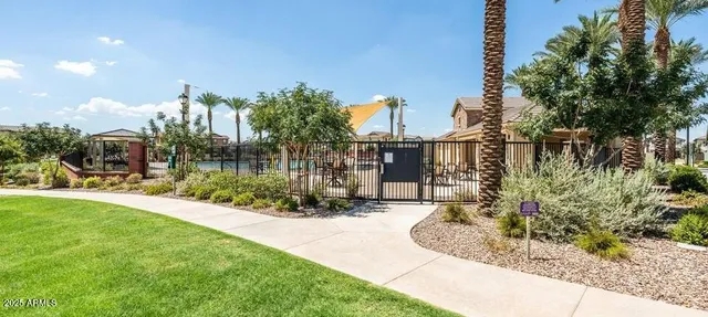 a view of a garden with a building in the background