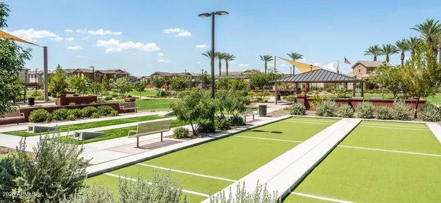 a view of a swimming pool with a patio and a yard