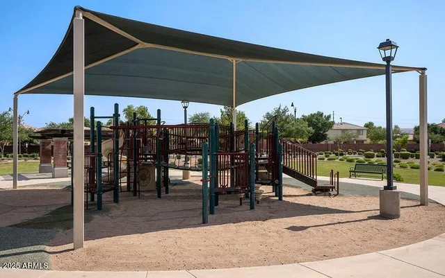 a view of tall trees with a patio