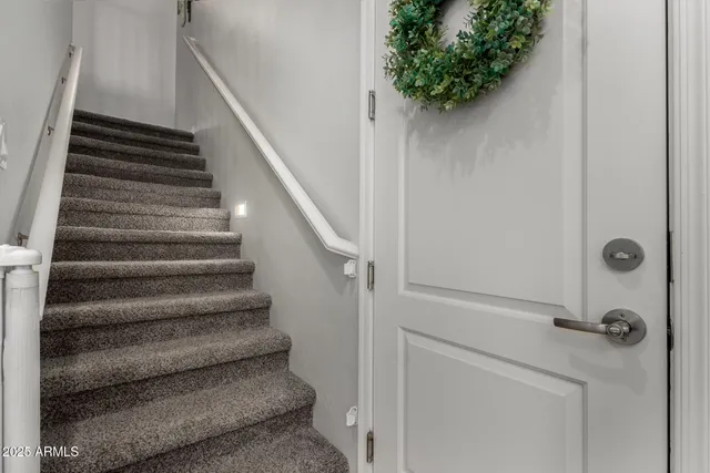 a view of staircase with white walls