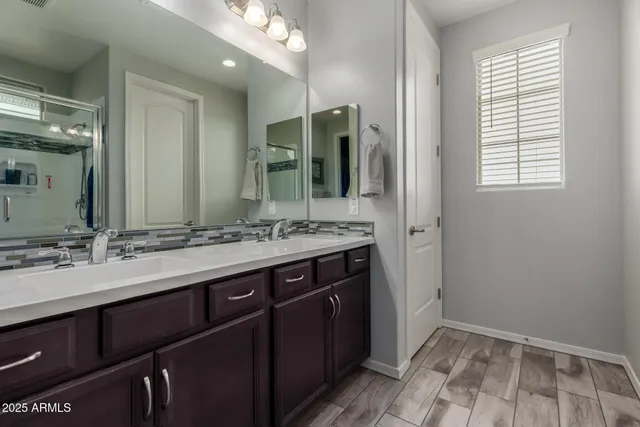 a bathroom with a double vanity sink and a mirror
