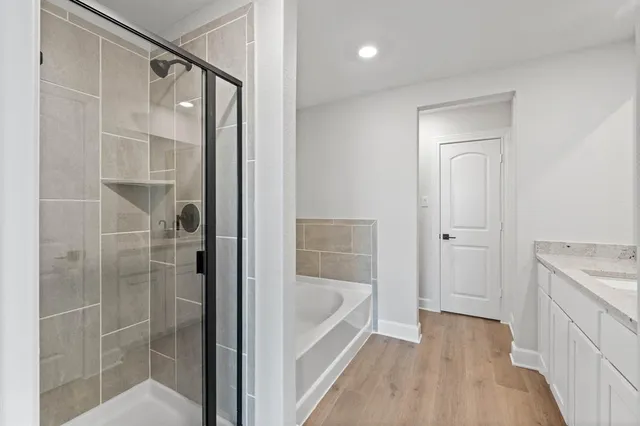 a bathroom with a bathtub and shower