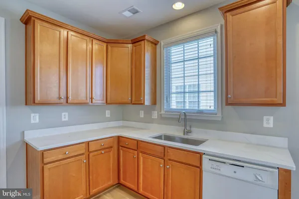 a kitchen with a sink cabinets and window