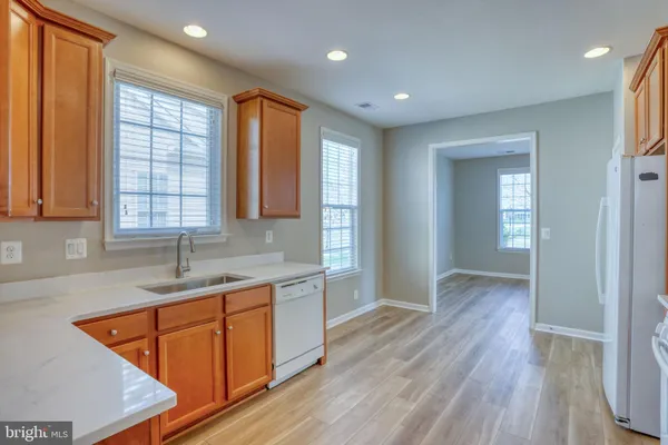 a kitchen with sink cabinets and wooden floor