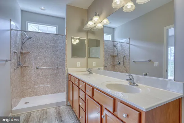 a bathroom with a sink double vanity and a shower