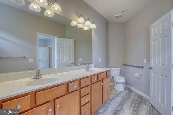 a bathroom with a sink a toilet and a mirror