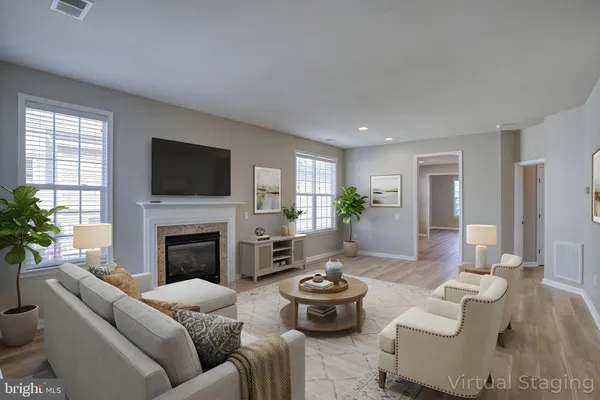 a living room with furniture fireplace and a flat screen tv
