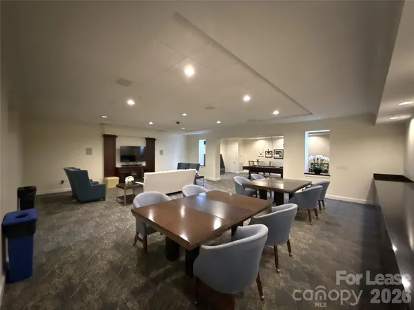 a living room with furniture a table and a piano