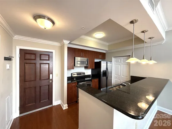 a kitchen with stainless steel appliances granite countertop a stove and a refrigerator