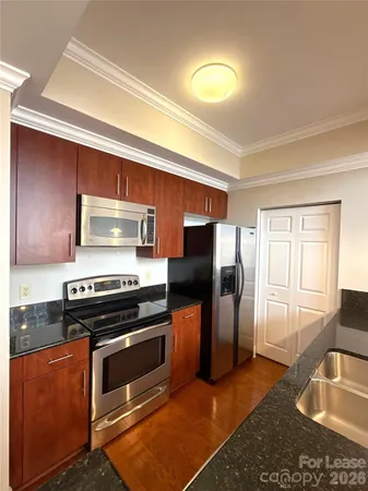 a kitchen with a stove a refrigerator and a sink
